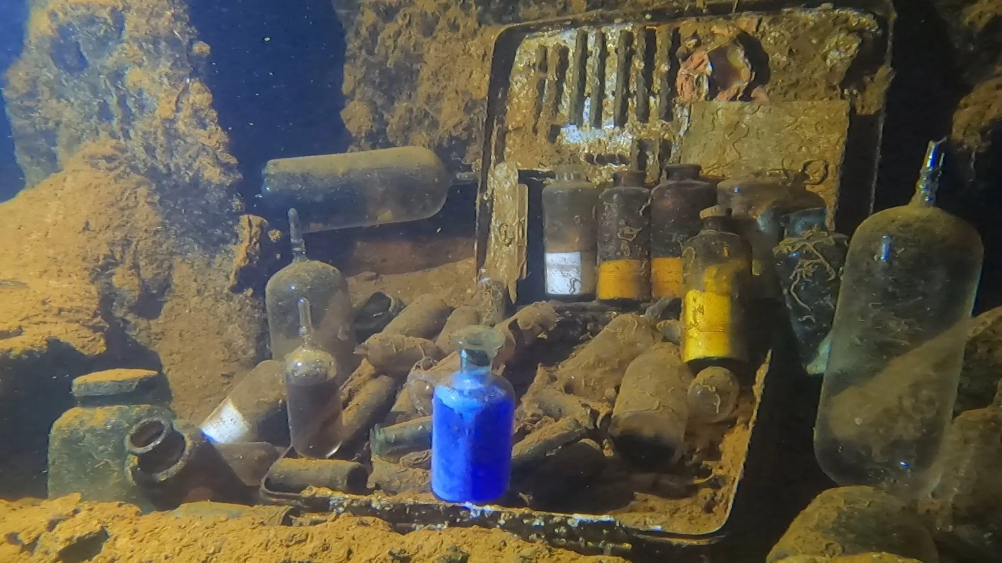 WWII wreck interior, Truk Lagoon — preserved cargo of medical bottles